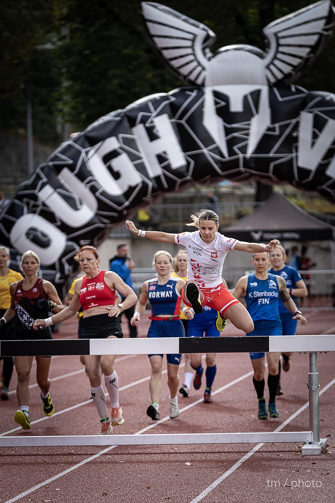Determined OCR runner showing intense facial expression during endurance challenge