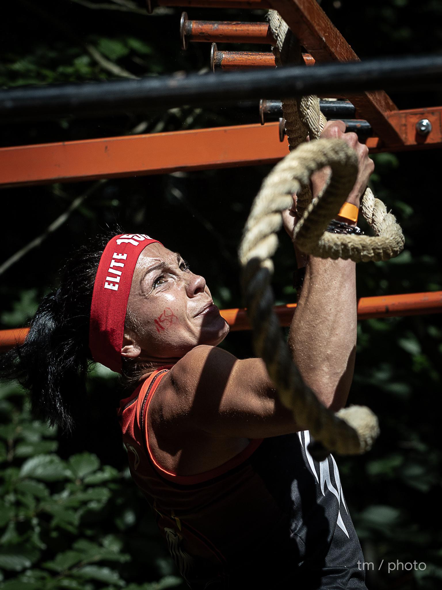 OCR participant battling through water obstacle in extreme conditions